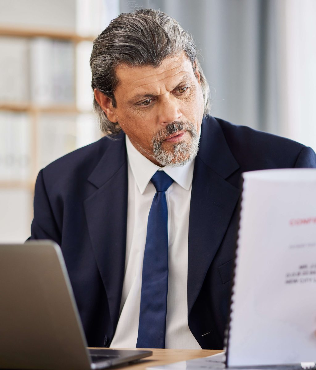 Lawyer, confidential and paperwork with man reading patient file and documents in office. Complianc